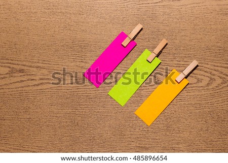 group of note and clothespin on wooden desk