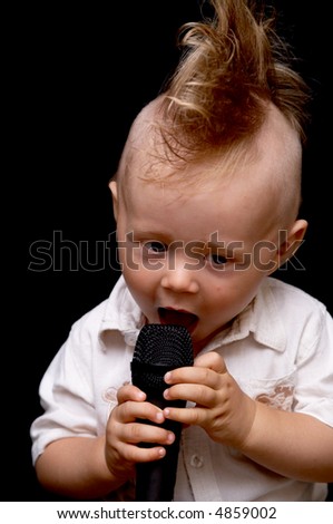 Portrait of the boy, singing in a microphone, with a ridiculous hairdress