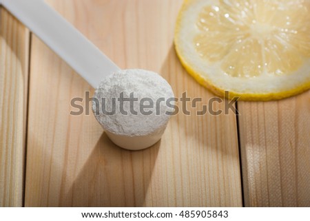 Sport supplement or vitamin with a lemon slice. Sport nutrition and health concept.