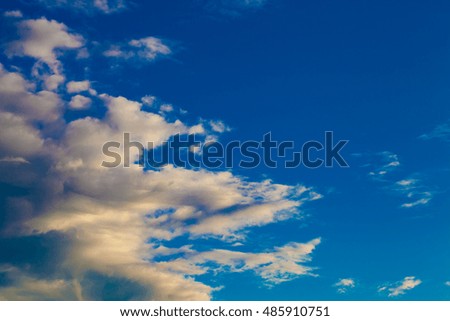 Blue sky with white cumulus clouds. Toned.