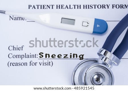 Chief complaint sneezing. Paper patient health history form, on which is written the complaint sneezing as the main reason for visit to the doctor, with a thermometer and stethoscope