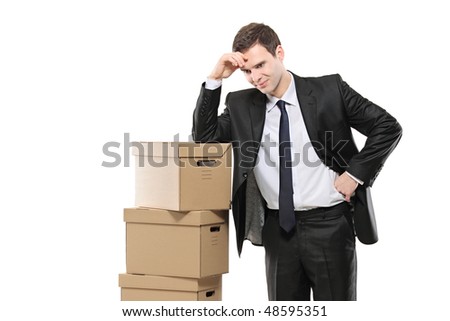 Thoughtfull businessman with paper boxes isolated on white background