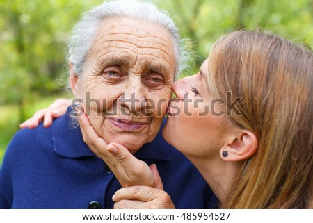 Picture of a senior woman with her caring granddaughter