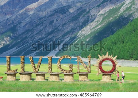 Welcome sign for village of Livigno, near the picturesque lake in valley surrounded by Italian Alps. Ski resort Livigno, Lombardy, Italy