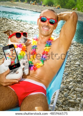jack russell dog with owner wearing funny fancy red sunglasses, lying on hammock or beach chair lounger together as lovers or friends, on summer vacation holidays taking a selfie together