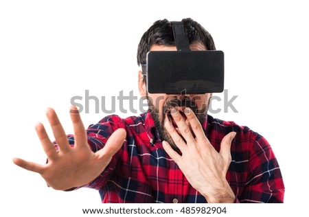 Man using VR glasses doing surprise gesture
