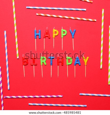 Happy Birthday flat lay party decorations on red background
