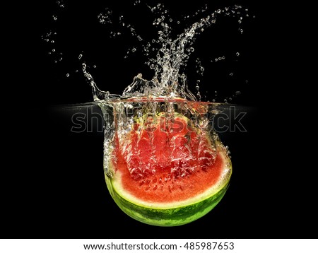 Fresh melon falling in water with splash on black background.