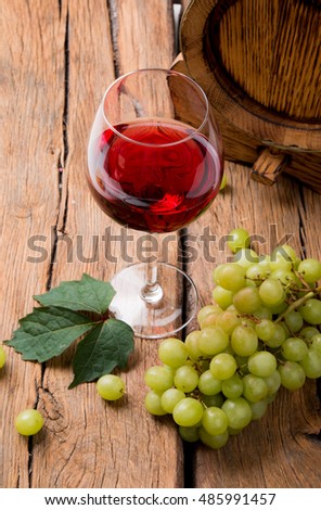 Wine glasses rose. Cheese on wooden table with fresh grapes 
