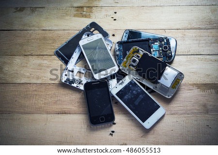 Broken smart phone with tone and wooden texture background