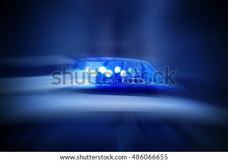police car with blue lights switched on Royalty-Free Stock Photo #486066655