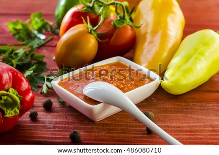 hot sauce adjika with fresh vegetables for cooking