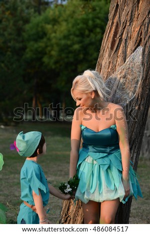 Mother dressed as a fairy and her son as Peter Pan