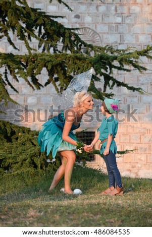 Mother dressed as a fairy and her son as Peter Pan
