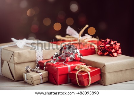 Composite image of presents on table against lightened background