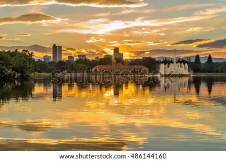 Golden Sunset at City Park - A summer sunset view of Ferril Lake in Denver City Park, with city skyline and front range mountains in the background, at east-side of Downtown Denver, Colorado, USA.