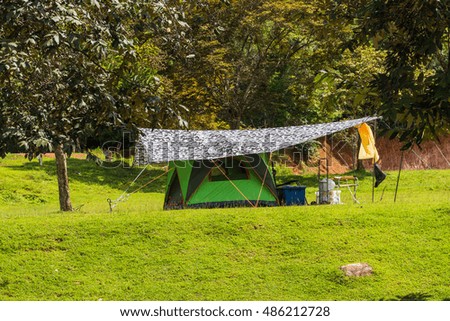 The camping tent on the field.