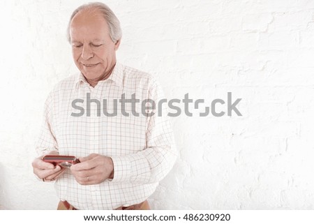 Senior man holding digital camera