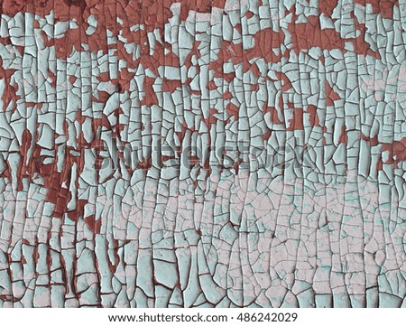 Cracked and peeling paint on a wooden wall. Red and white texture
