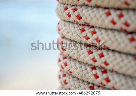 Close up capture of nautical rope wrapped on blue background