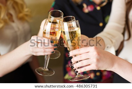 Hands holding the glasses of champagne making a toast