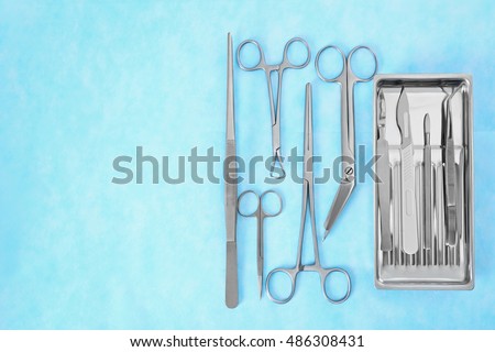Flat lay of medical instruments on blue background Royalty-Free Stock Photo #486308431