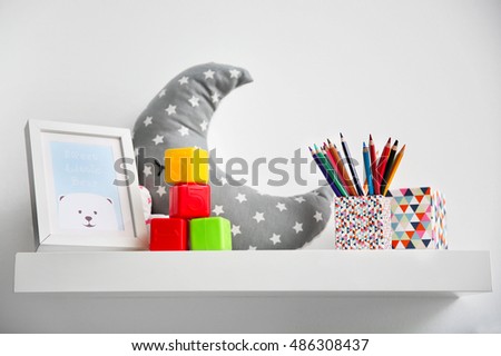 Decorative shelf on wall as detail of kid room interior