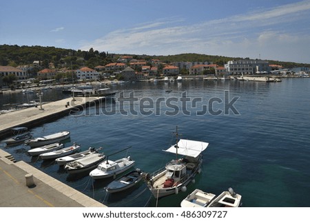 Postira harbor view to the west with some boats in foreground picture from Postira Brac Croatia.