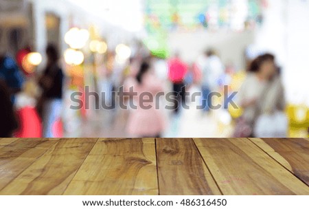 blurred image wood table and people shopping in supermarket