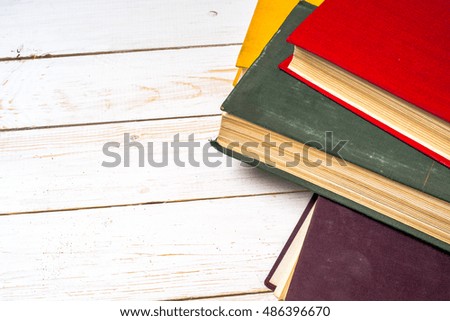 Stack of colorful books, grungy blue background, free copy space. Back to school. Education background.