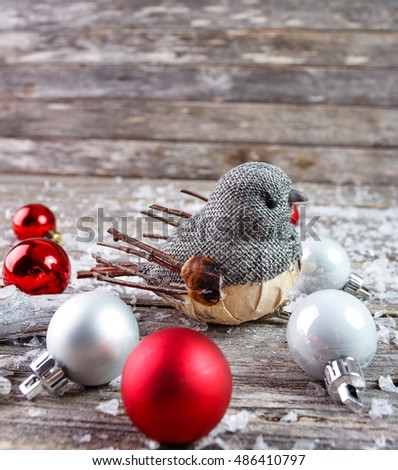 Christmas decoration with bird on wooden background. Empty space for text.
