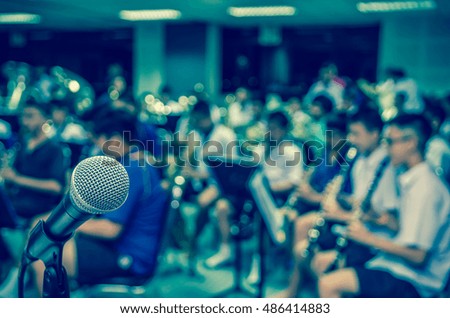 Microphone over the Abstract blurred photo of classic music band when rehearsal, musical concept, seminar meeting concept