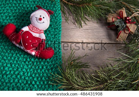 Christmas tree decoration snowman wooden texture background woolen warm wear new year green