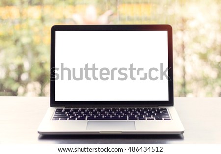 Front view of the laptop is on the work table, blurred background, clipping path inside
