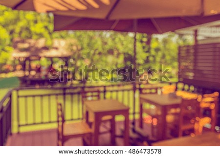 image of Abstract blurred outdoor coffee hut on day time in garden for background usage . (vintage tone)