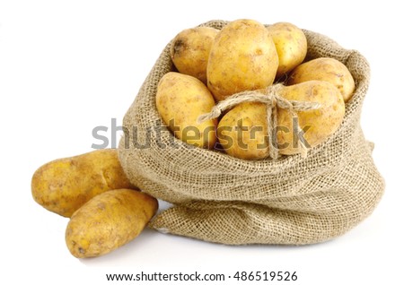 How to store Potatoes.
A lot of Potatoes in sack clothe on white background.