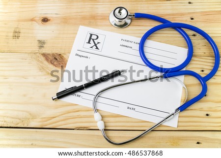 Doctor desk with medical stethoscope and blanked diagnosis information prescription form.