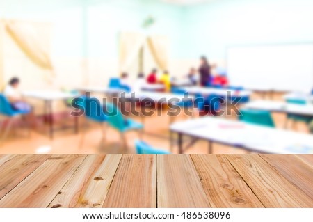 Look out from the table, blur image of classrooms as background.