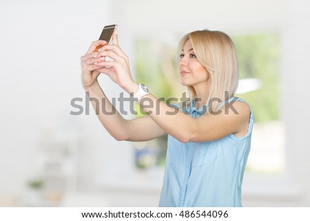 teenage girl making selfie photo with smart phone