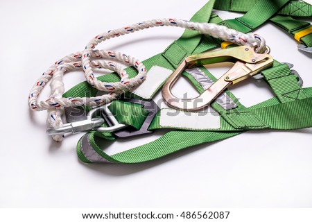 Closeup fall protection Hook harness and lanyard for work at heights on white background. Royalty-Free Stock Photo #486562087