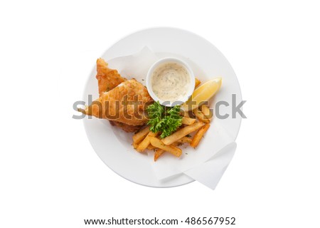 Top view of traditional British style fish and chips including deep fried cod, french fries, lemon, and tartar sauce in ceramic dish isolated on white background