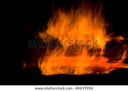 Closeup of burning red fire wood on black background