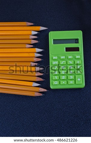 close up of protractor, calculator and pencil