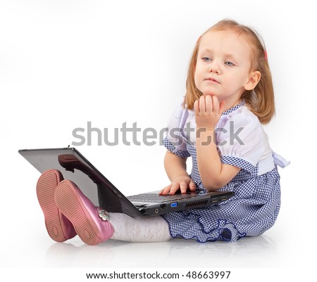 Little girl playing with laptop, isolated white background