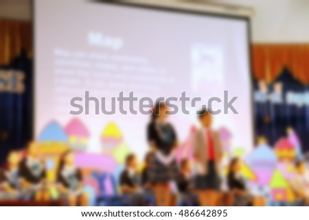 The blurry photo of young student do activity on stage of meeting hall scene represent the people and activity concept related background idea.