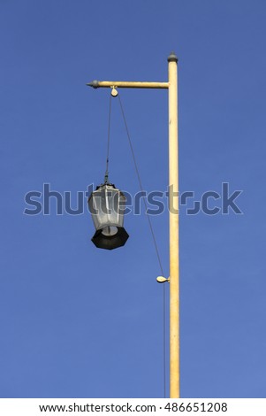 Lantern pole on the roof of chinese shrine with blue sky background.