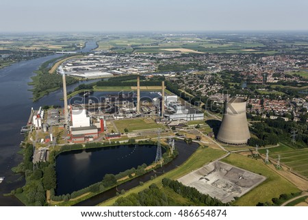 Aerial view of  a coal and biomass fired powerplant. It's located at the river Amer. In the back the town of GEERTRUIDENBERG. 