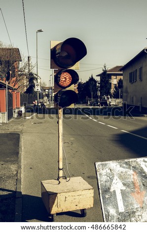 Vintage looking Road works with temporary traffic light