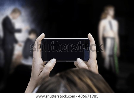 Woman hand holding contemporary modern smartphone. Visual effects. Blank display replaceable with needed design.Horizontal mockup