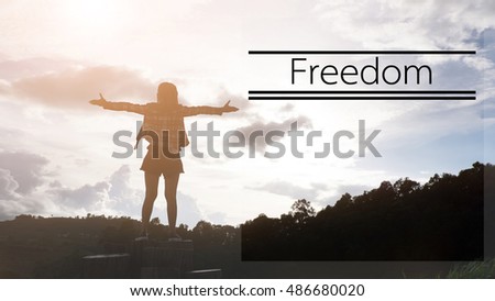 Silhouette of Girl enjoying the freedom in a view from top of a mountain.Freedom concept,at word is "FREEDOM".